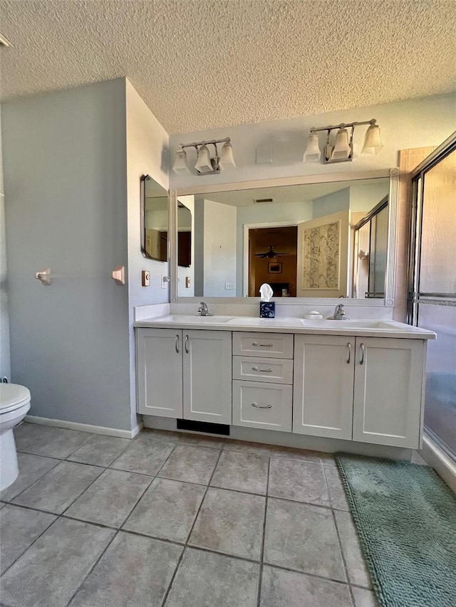 bathroom featuring vanity, tile patterned flooring, and a textured ceiling