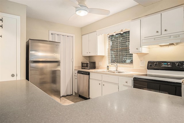 kitchen featuring light countertops, appliances with stainless steel finishes, white cabinets, a sink, and under cabinet range hood