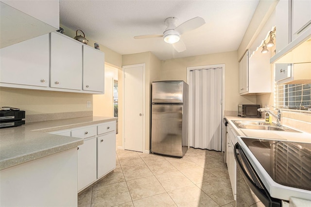 kitchen with white cabinetry, appliances with stainless steel finishes, light countertops, and a sink