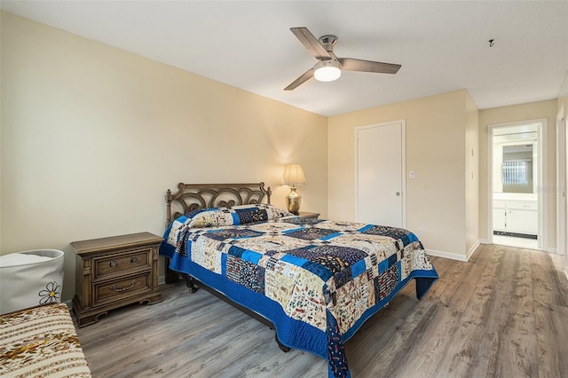 bedroom with a ceiling fan, baseboards, and wood finished floors