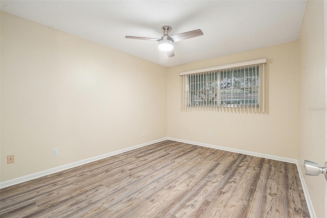 unfurnished room featuring ceiling fan, baseboards, and wood finished floors