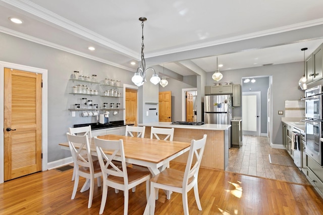 dining room featuring light wood-type flooring and ornamental molding