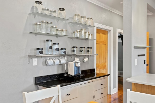 bar featuring crown molding and dark hardwood / wood-style flooring