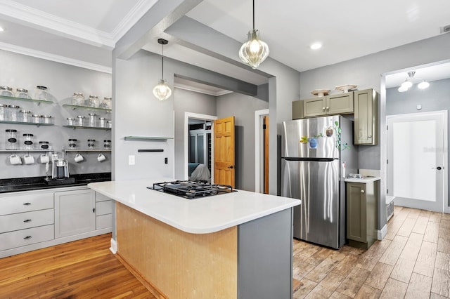 kitchen featuring a center island, decorative light fixtures, stainless steel refrigerator, black gas cooktop, and light hardwood / wood-style floors