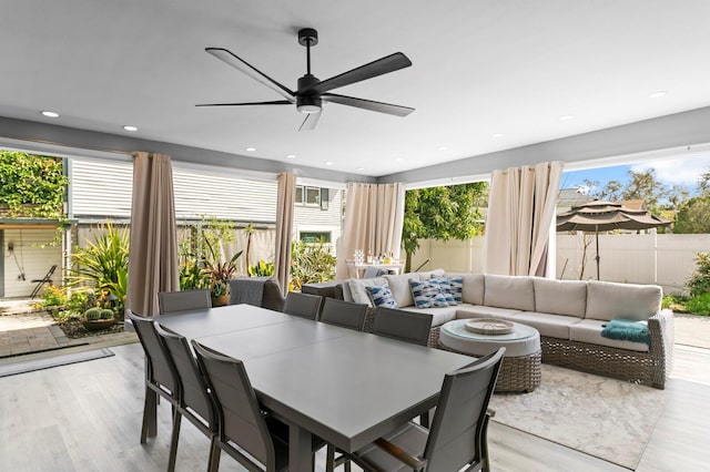 dining area with light wood-type flooring, plenty of natural light, and ceiling fan