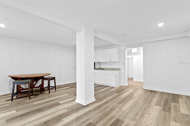 living room featuring light hardwood / wood-style flooring and sink