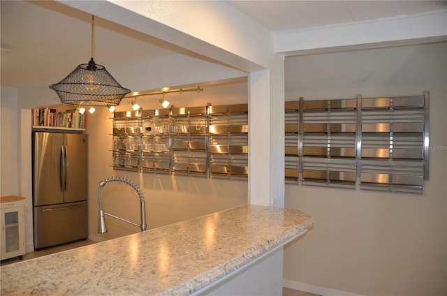 kitchen featuring wine cooler, sink, stainless steel fridge, and decorative light fixtures