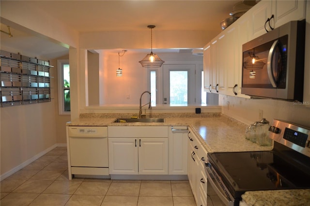 kitchen featuring sink, appliances with stainless steel finishes, white cabinetry, and hanging light fixtures