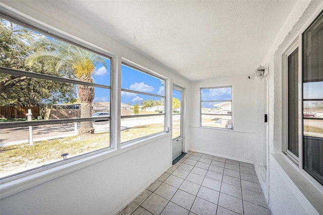 unfurnished sunroom with lofted ceiling