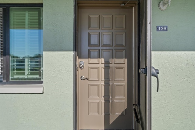 entrance to property with stucco siding