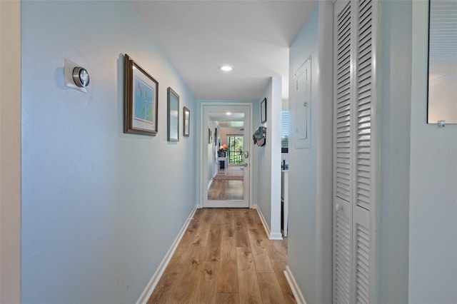 corridor with recessed lighting, light wood-style flooring, and baseboards