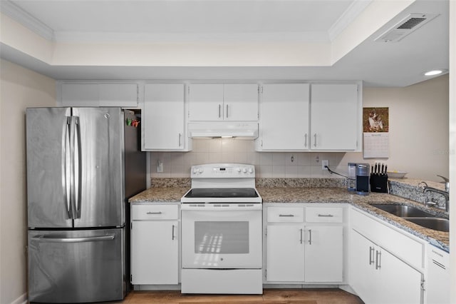 kitchen with under cabinet range hood, white cabinets, white electric range, and freestanding refrigerator