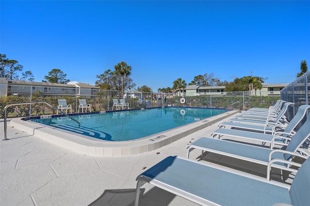 pool featuring a patio area and fence