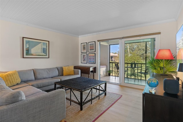 living room with light wood-style flooring and ornamental molding