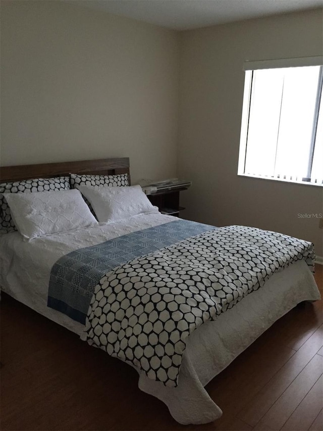 bedroom featuring dark wood-style flooring