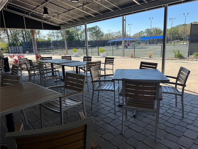 128 Nancy Dr Unit 128, Oldsmar, FL 34677 - view of patio featuring a tennis court and outdoor dining space