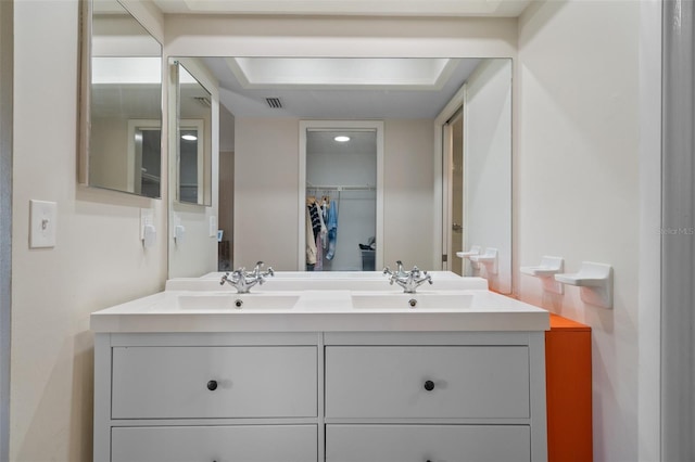 128 Nancy Dr Unit 128, Oldsmar, FL 34677 - bathroom featuring double vanity and a walk in closet