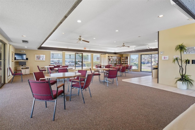 128 Nancy Dr Unit 128, Oldsmar, FL 34677 - carpeted dining space featuring a textured ceiling, recessed lighting, a tray ceiling, tile patterned floors, and a ceiling fan