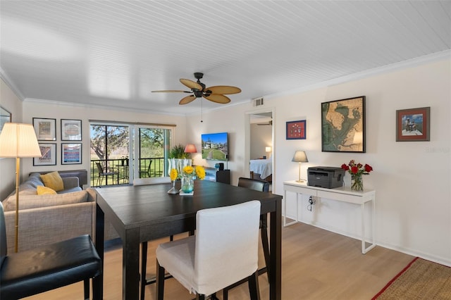 128 Nancy Dr Unit 128, Oldsmar, FL 34677 - dining room featuring ceiling fan, crown molding, and light wood finished floors