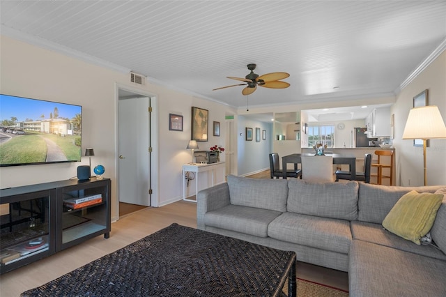 128 Nancy Dr Unit 128, Oldsmar, FL 34677 - living room featuring crown molding, light wood-type flooring, and ceiling fan