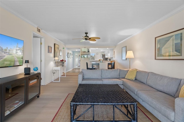 128 Nancy Dr Unit 128, Oldsmar, FL 34677 - living area with light wood-style floors, ornamental molding, and ceiling fan