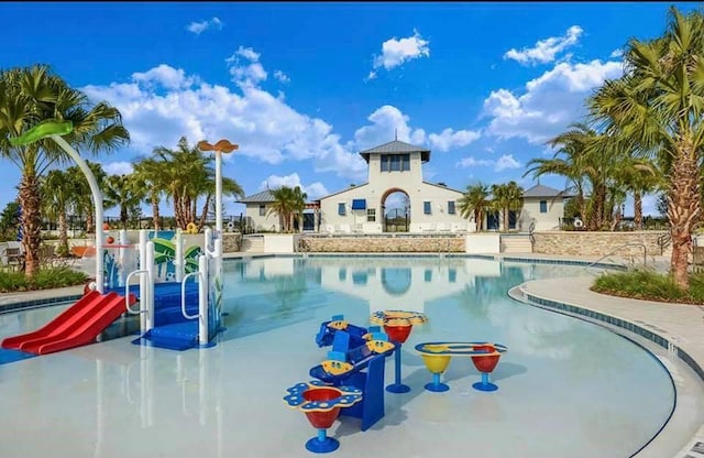 view of swimming pool with a water slide