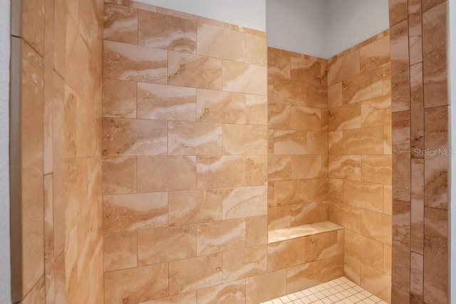 bathroom with a tile shower