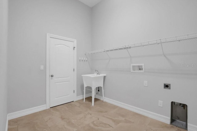 clothes washing area featuring baseboards, laundry area, hookup for a washing machine, and hookup for an electric dryer