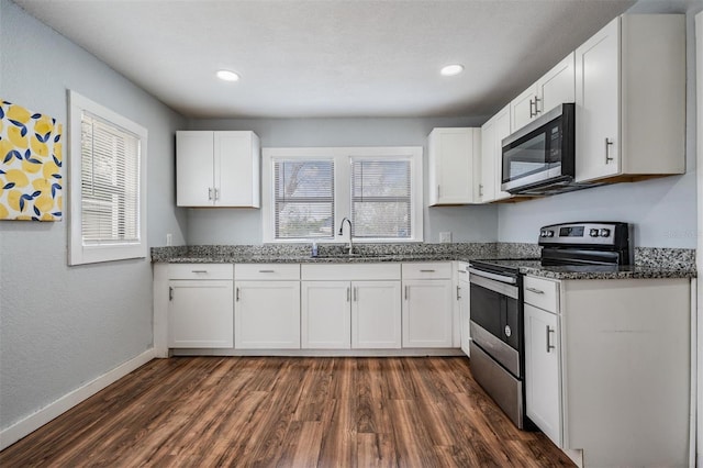 kitchen with appliances with stainless steel finishes and white cabinets