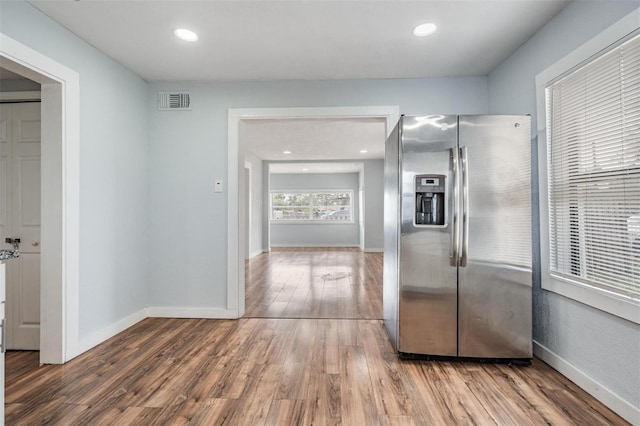 interior space featuring recessed lighting, visible vents, baseboards, and wood finished floors