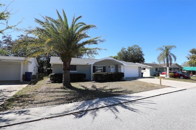 ranch-style house with a garage and central AC