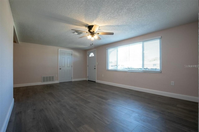 entrance foyer featuring ceiling fan, dark hardwood / wood-style flooring, and a textured ceiling