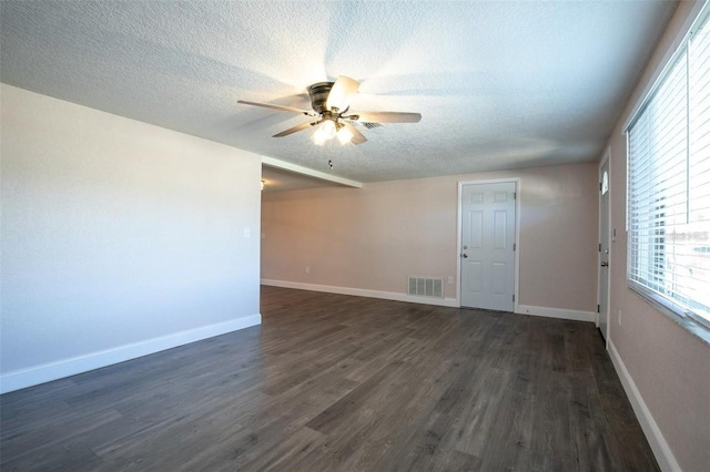 unfurnished room featuring a textured ceiling, dark wood-type flooring, and ceiling fan