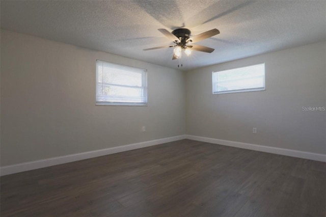 empty room featuring dark hardwood / wood-style floors, a textured ceiling, and ceiling fan