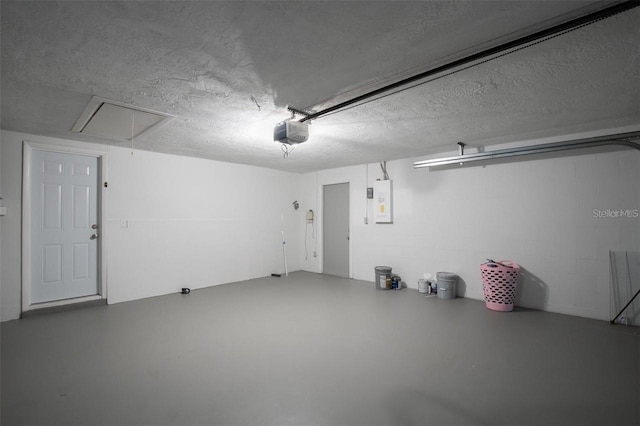 garage featuring a garage door opener and electric panel