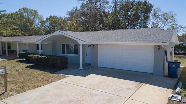 single story home featuring a garage and a front yard