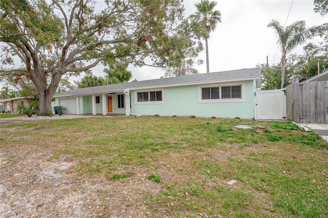 ranch-style house with a garage and a front yard