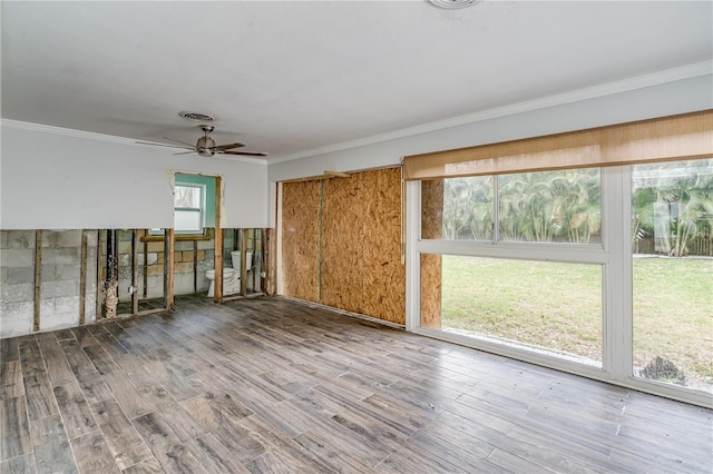 empty room featuring crown molding, hardwood / wood-style flooring, and ceiling fan