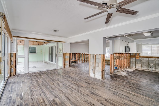 empty room with crown molding, wood-type flooring, and ceiling fan