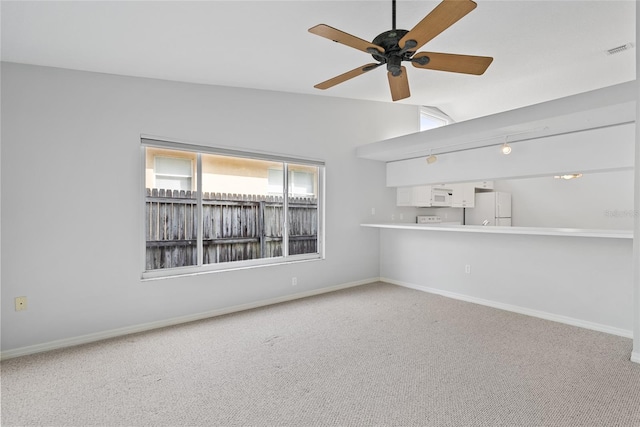 45 Gulfwinds Dr W, Palm Harbor, FL 34683 - unfurnished living room with carpet floors, a ceiling fan, vaulted ceiling, and baseboards