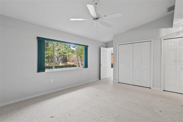 45 Gulfwinds Dr W, Palm Harbor, FL 34683 - unfurnished bedroom with lofted ceiling, multiple closets, baseboards, a ceiling fan, and carpet floors