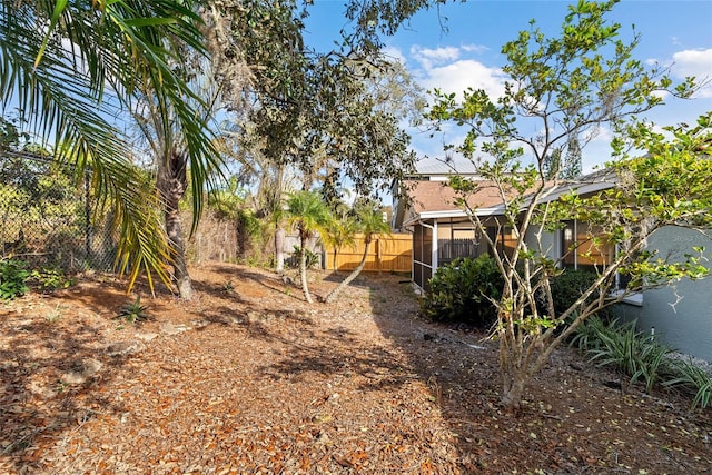 45 Gulfwinds Dr W, Palm Harbor, FL 34683 - view of yard featuring a sunroom and fence