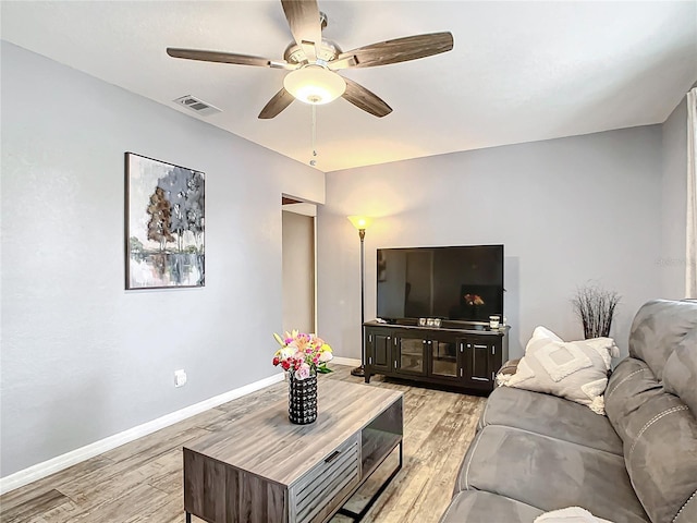 living room with ceiling fan and light hardwood / wood-style floors