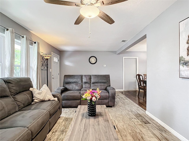 living room featuring ceiling fan and light wood-type flooring