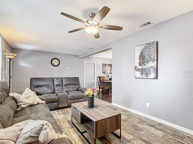 living room with ceiling fan and light wood-type flooring