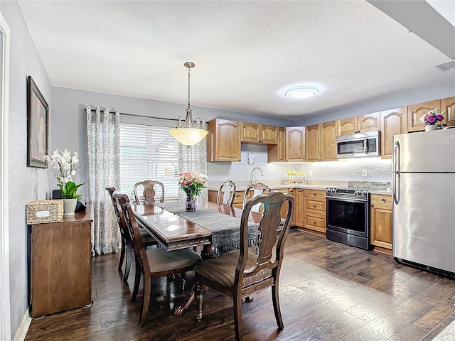 dining space featuring dark hardwood / wood-style floors and sink