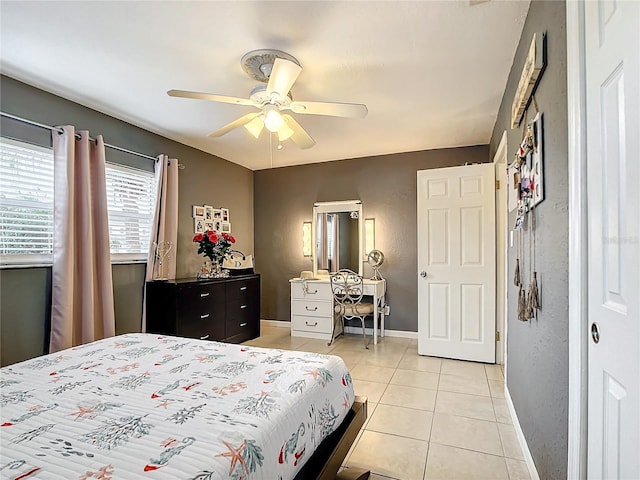 tiled bedroom featuring ceiling fan