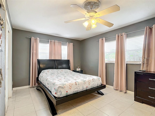 tiled bedroom featuring ceiling fan