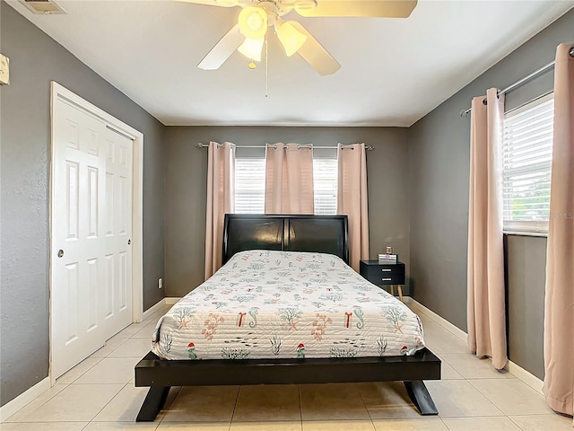 tiled bedroom with ceiling fan