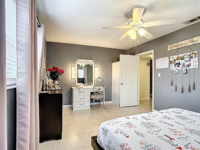 tiled bedroom featuring ceiling fan